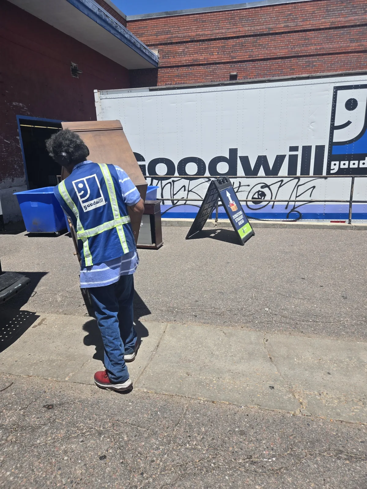 Junk Same Day crew donating a dresser to Goodwill in Denver