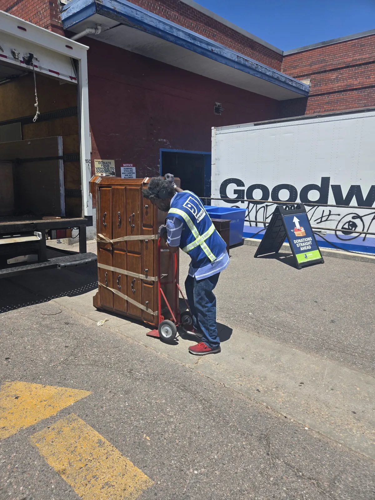 Goodwill attendant receiving a donated dresser from Junk Same Day