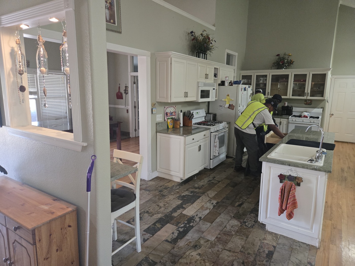 Junk Same Day crew clearing a kitchen during an eviction cleanout