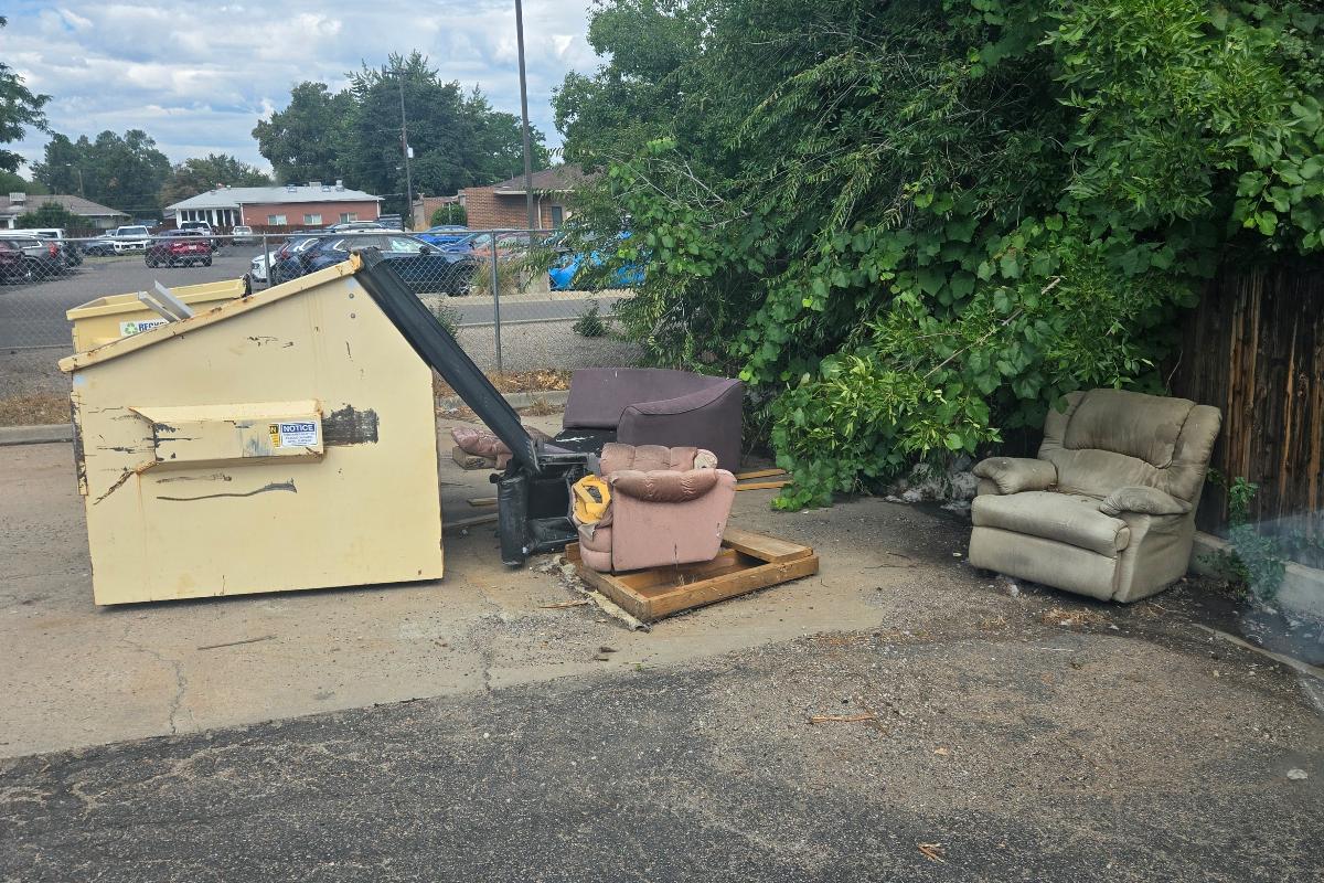 Eviction set-out with furniture and mattress at the curb in Denver metro