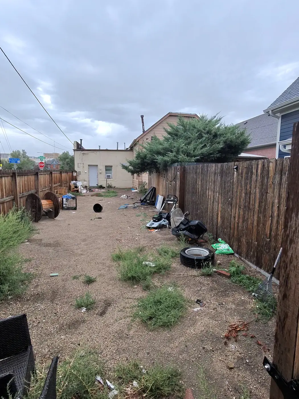 Alley strip with scattered junk before cleanup