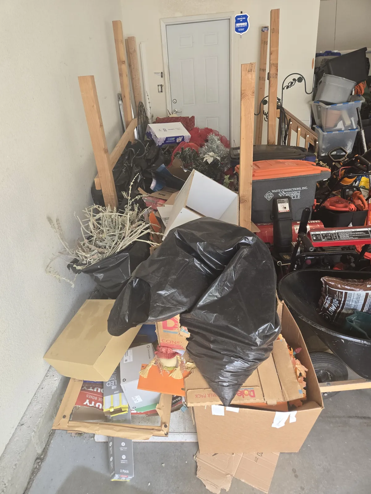 Garage corner piled with junk before cleanout